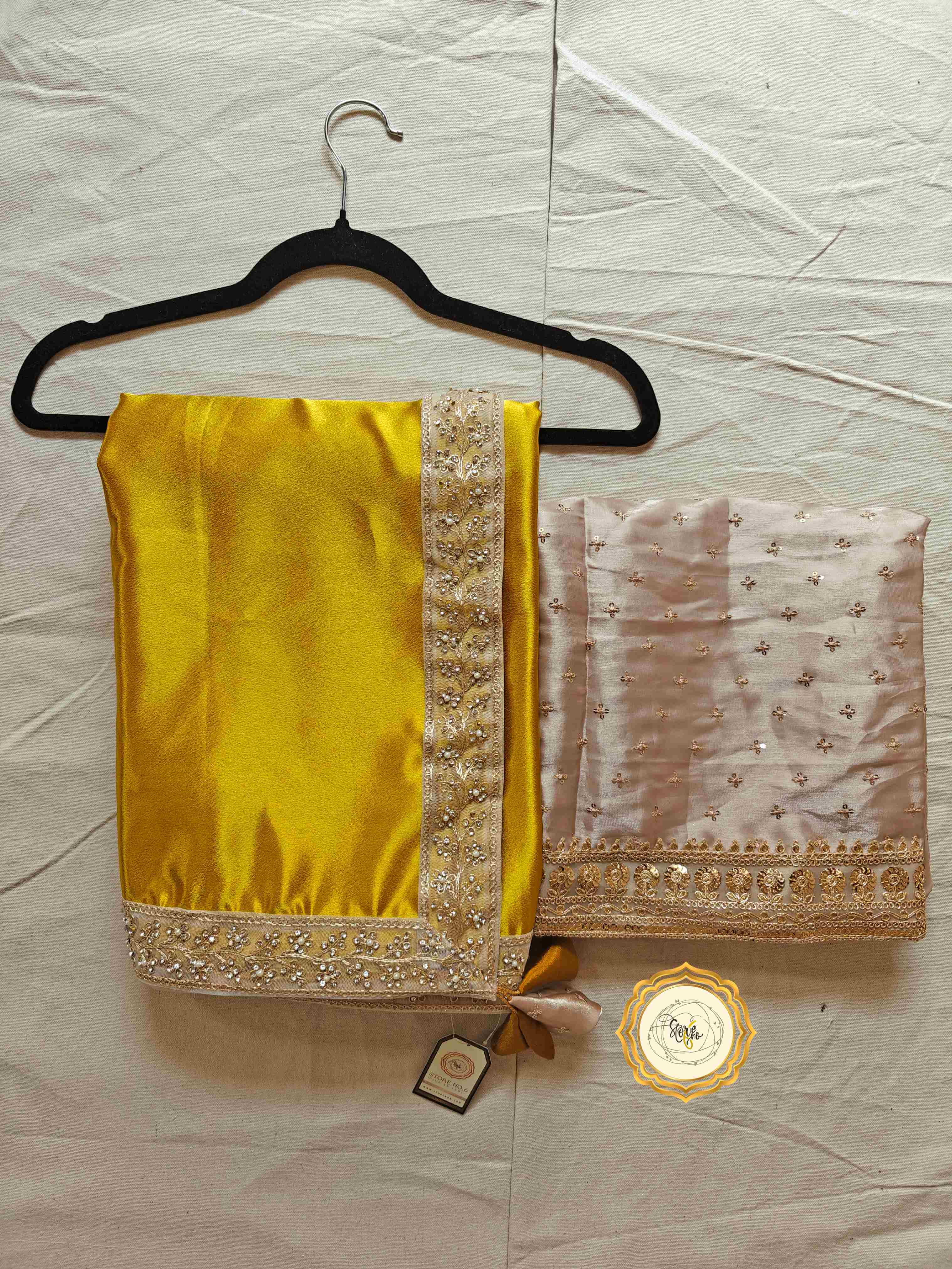 Elegant satin saree with blouse featuring a vibrant yellow satin fabric and embellished organza blouse piece.