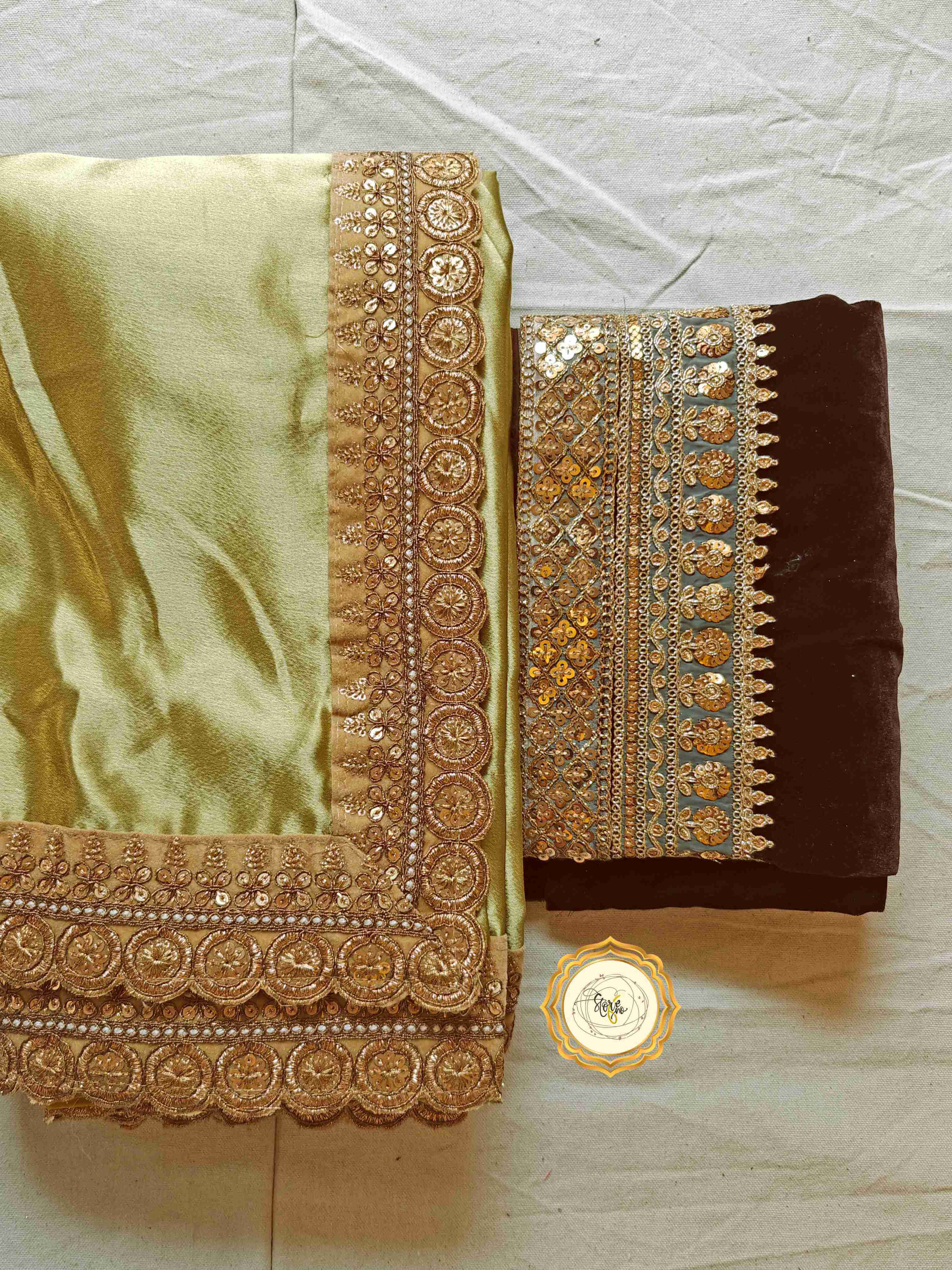 Classic pre draped satin saree with unstitched blouse featuring olive green fabric and chocolate velvet.