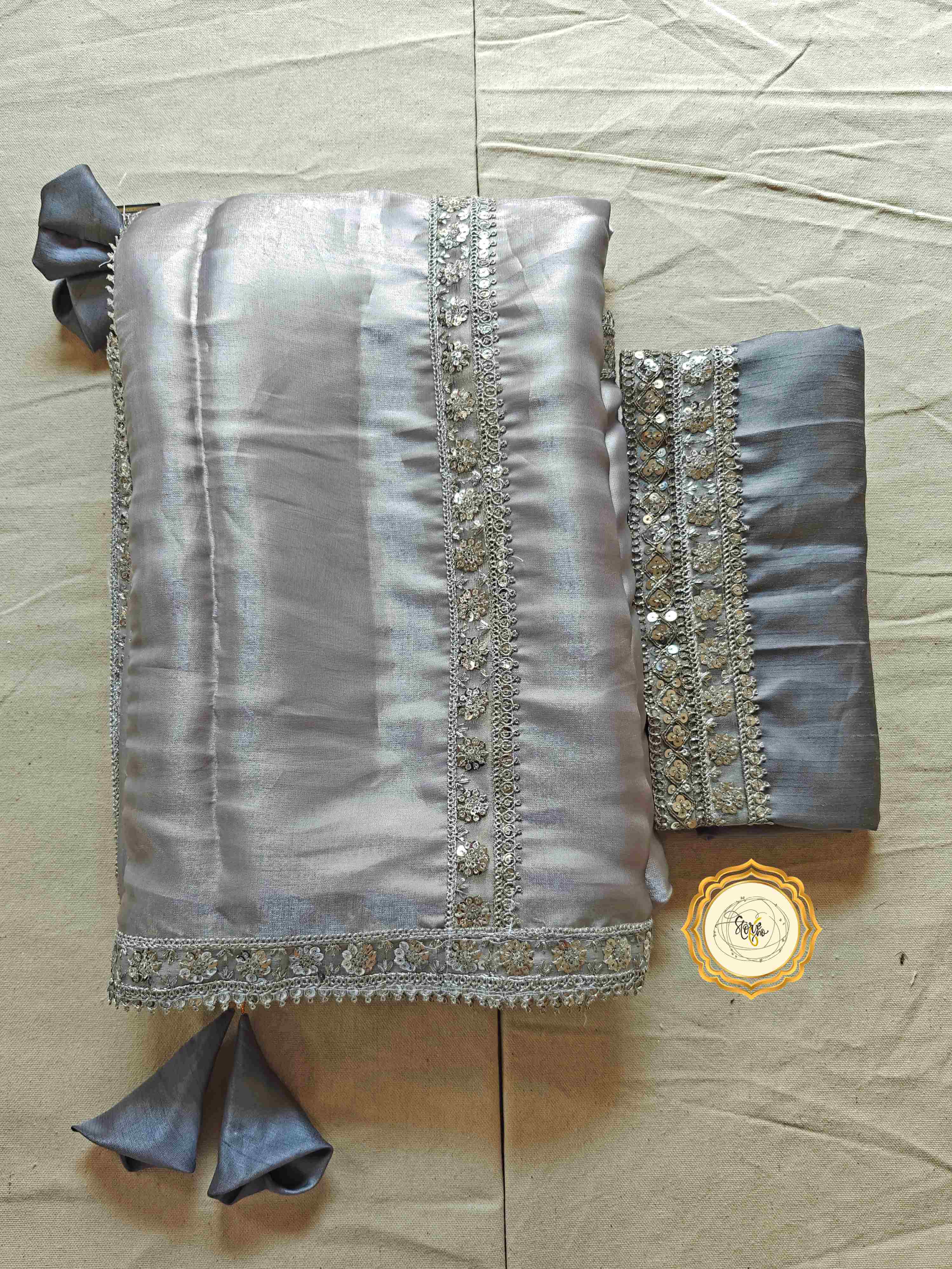 silver organza saree with blouse featuring tassels and lace work