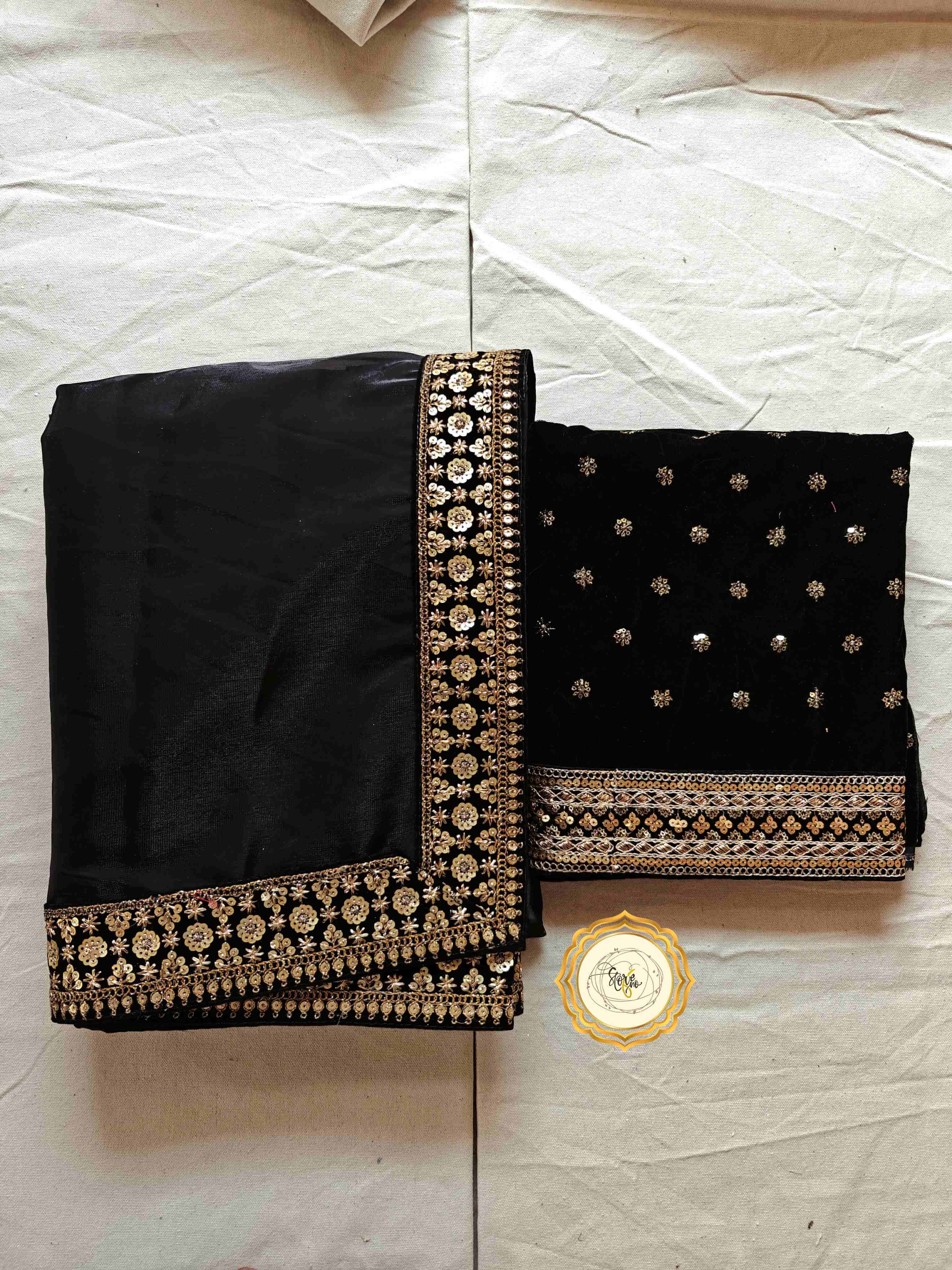 Classic black partywear saree with unstitched blouse featuring stunning lace and embroidered designs.