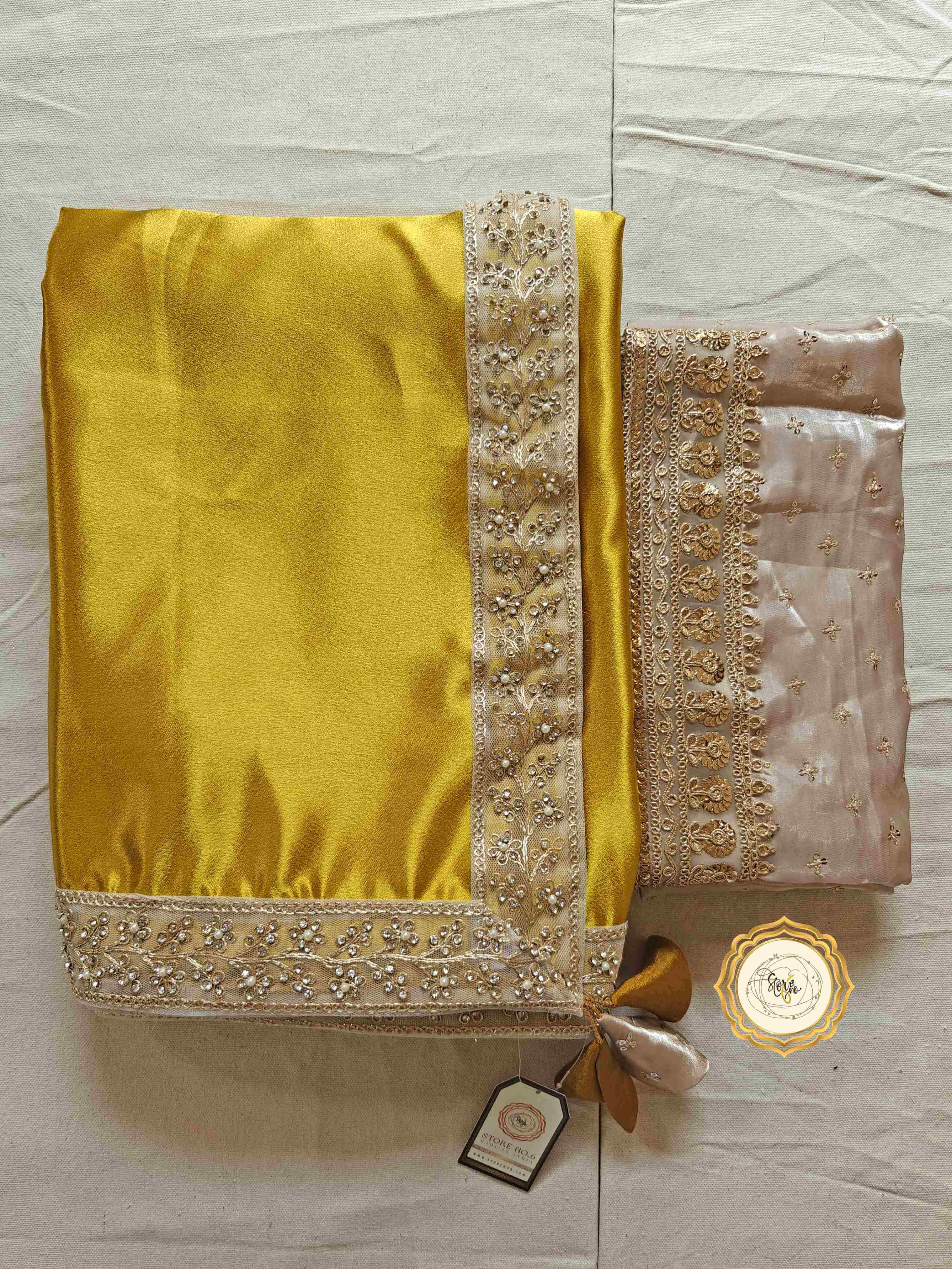 Elegant satin saree with blouse featuring a vibrant yellow satin fabric and embellished organza blouse piece.