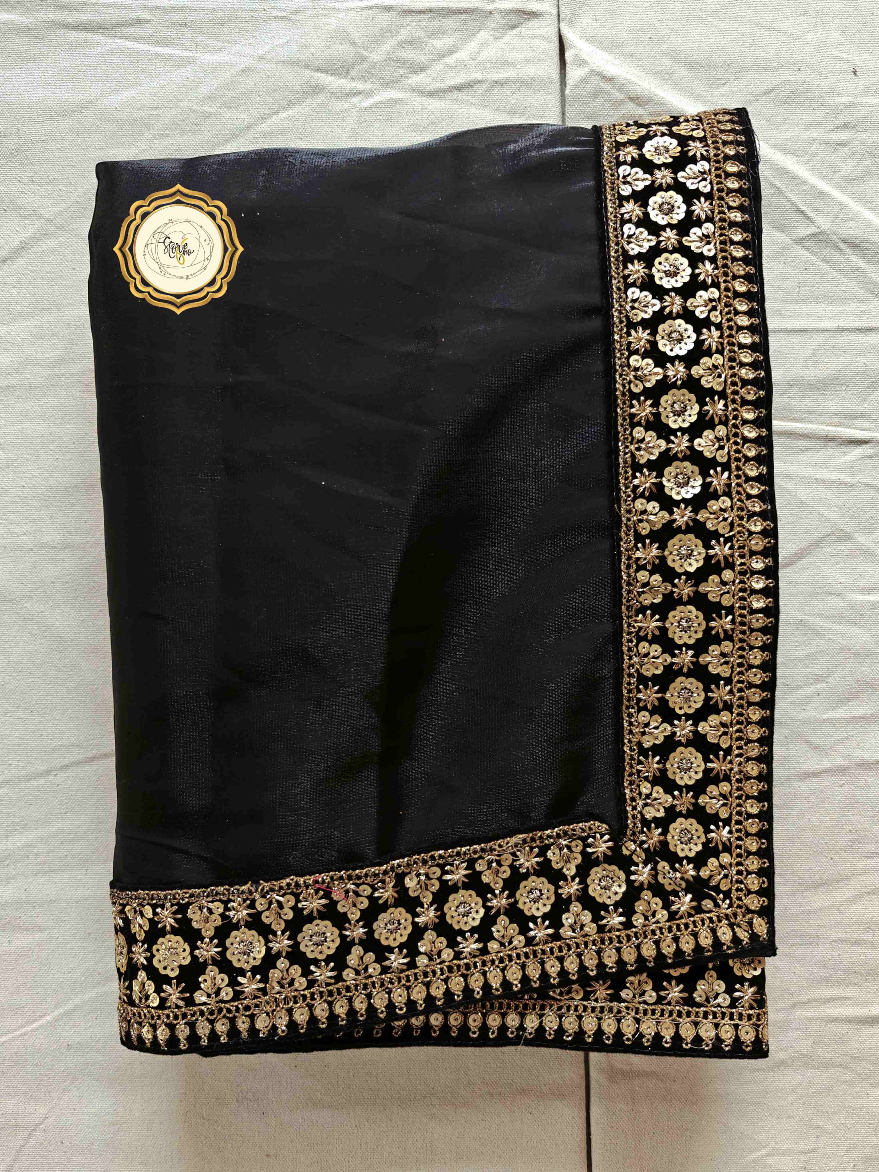 Classic black partywear saree featuring stunning lace work and intricate border design.